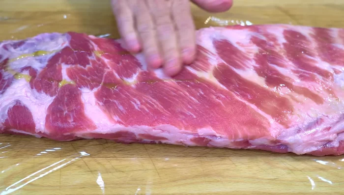 Season the ribs generously with the spice mixture, ensuring even coverage.