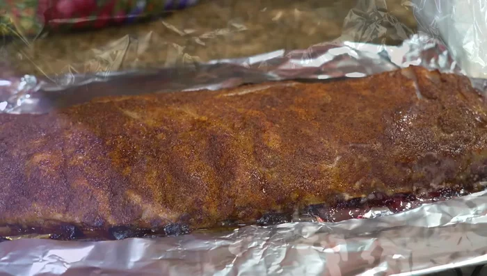 Unwrap the ribs after 1 hour, brush with glaze, and return to the oven for another 30 minutes.