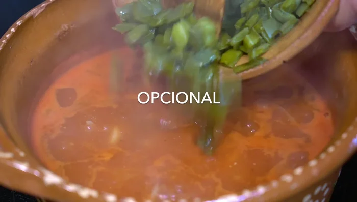 Add nopales and cook until flavors integrate. Add grilled cheese, lower heat, and cover until cheese softens.