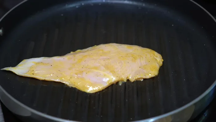 Grill chicken breasts until browned on both sides.
