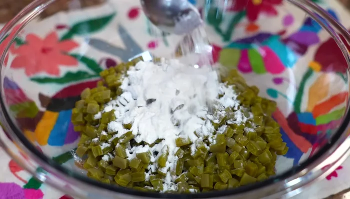 In a bowl, combine half the flour with the cooked cactus. This helps prevent the pancakes from falling apart.
