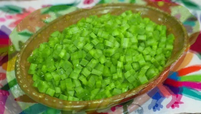 Wash and cut the cactus into small cubes. Sweat the cactus (if fresh) to release the slime. If using pre-cut cactus, cook them in water to prevent acidity.