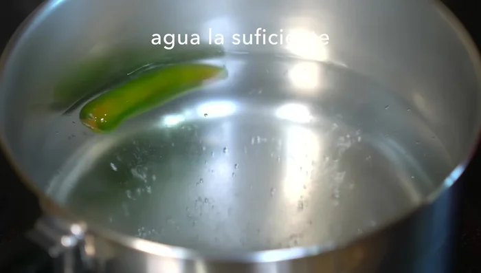 Prepare the sauce: Boil serrano pepper for 5-7 minutes, then add tomatoes and cook until skins burst. Remove from heat and let cool.