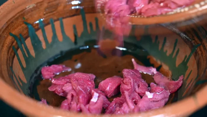 In a hot pan, fry the beef over high heat with the chopped onion until browned. Lower heat and cover to allow the meat to release its juices.