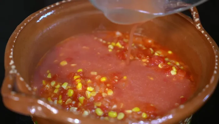 Add the blended tomato sauce, season with salt or chicken broth powder, and let the flavors integrate for about 6 minutes.