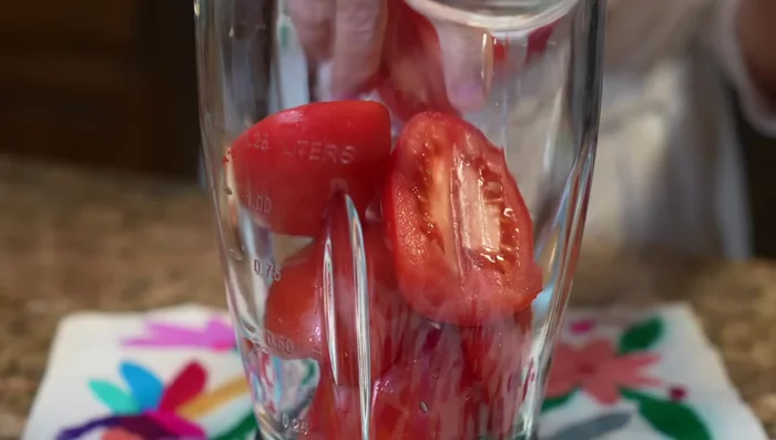 Blend tomatoes, quarter of an onion, and garlic with water until smooth.