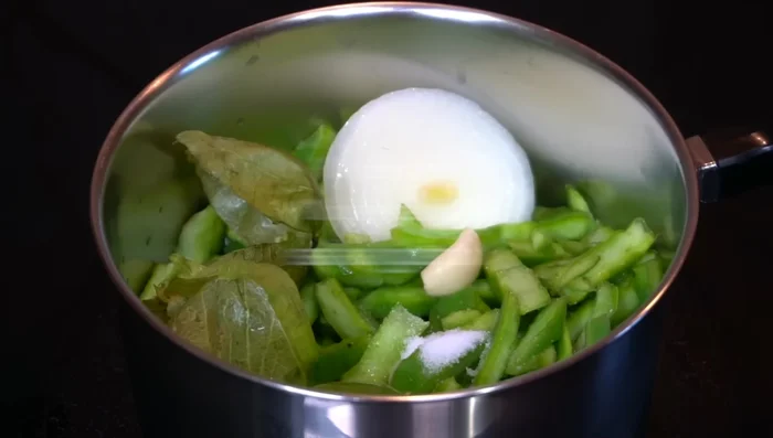 Cook nopales separately by sweating them with onion, garlic, salt, and green tomato peels.