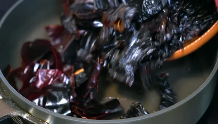 Lightly fry the chilies in hot oil over medium-low heat, stirring constantly to avoid burning.