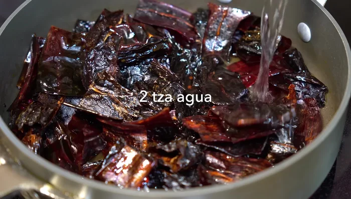 Add water to the chilies, cover, and let them hydrate for 15 minutes.