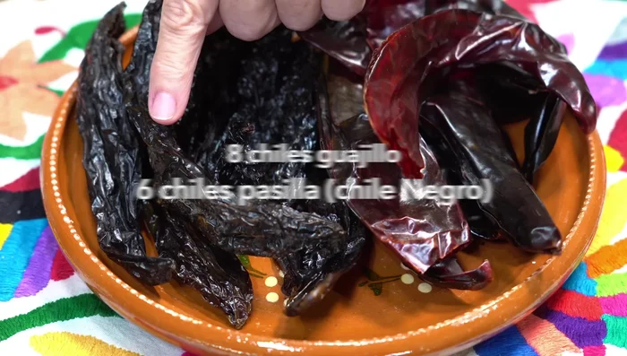 Prepare the marinade: Clean and remove seeds from guajillo and pasilla chilies.