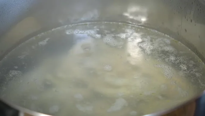 Place chicken feet in a pot of boiling water. Once boiling, remove any foam that rises to the surface.