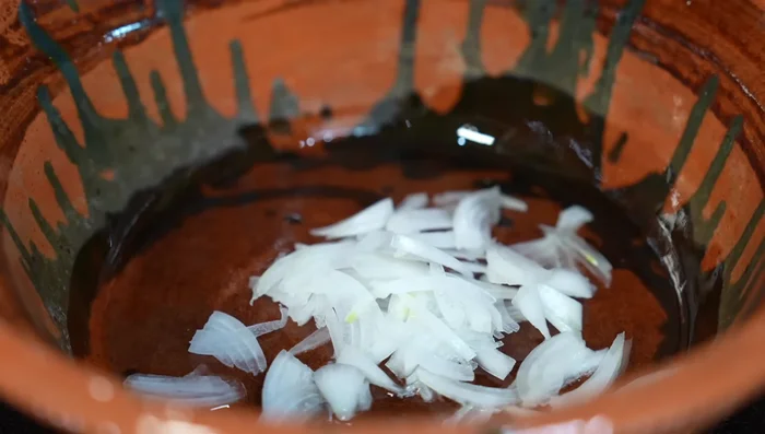 In hot oil, sauté onion strips for a couple of minutes. Add the cooked beef and fry with the onions.