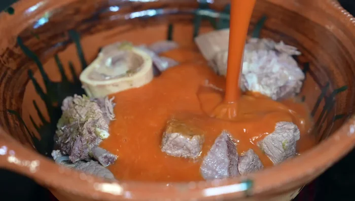 Add the red tomato sauce, more broth to make it brothy, and season with salt or chicken bouillon powder. Simmer for 20 minutes.
