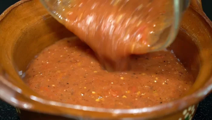 Add the blended sauce to the onion, season with salt, and simmer for 15 minutes.