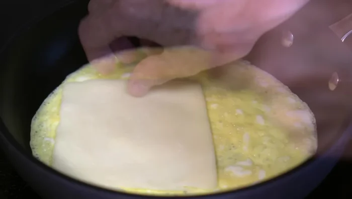 Add ham and cheese to the eggs.
