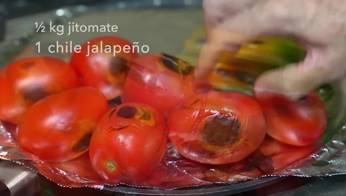 Roast tomatoes, jalapeño, and serrano peppers on a griddle until well-roasted.