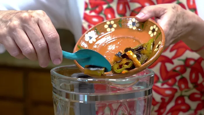 Blend roasted peppers, garlic, and water in a blender until smooth.