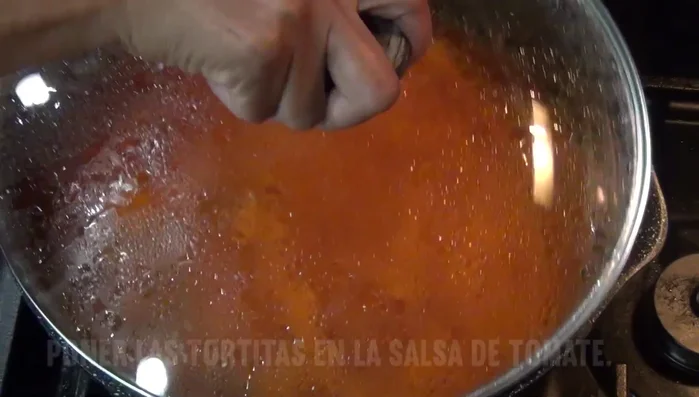 Serve the zucchini pancakes topped with the prepared tomato sauce.