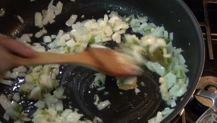After 3 minutes, add chopped tomatoes. After 15 minutes, stir in chopped parsley.