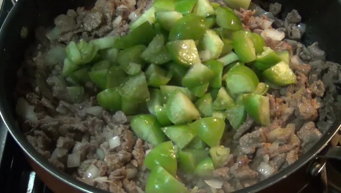 Add the chopped green tomatoes and chipotle peppers.