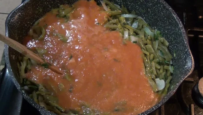 Pour in the blended tomato sauce. Season with salt to taste and add a cup of water. Bring to a boil.