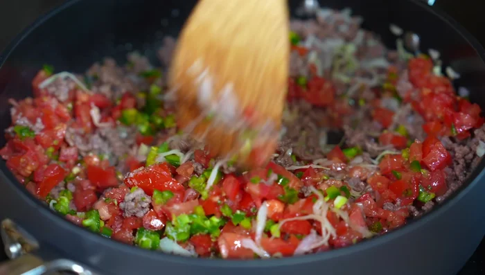 Stir and cook until the tomatoes release their juice.
