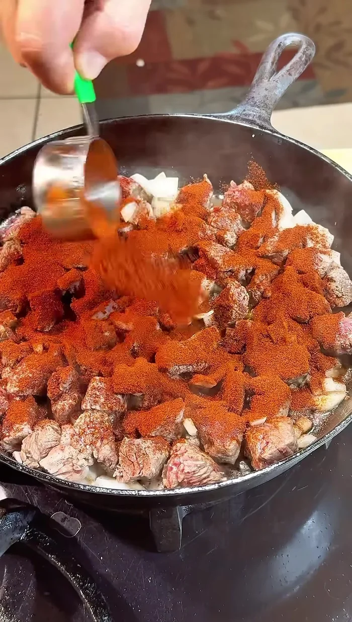 Add chimayo red chili powder (1/4 cup at a time), stirring to toast for a couple of minutes.