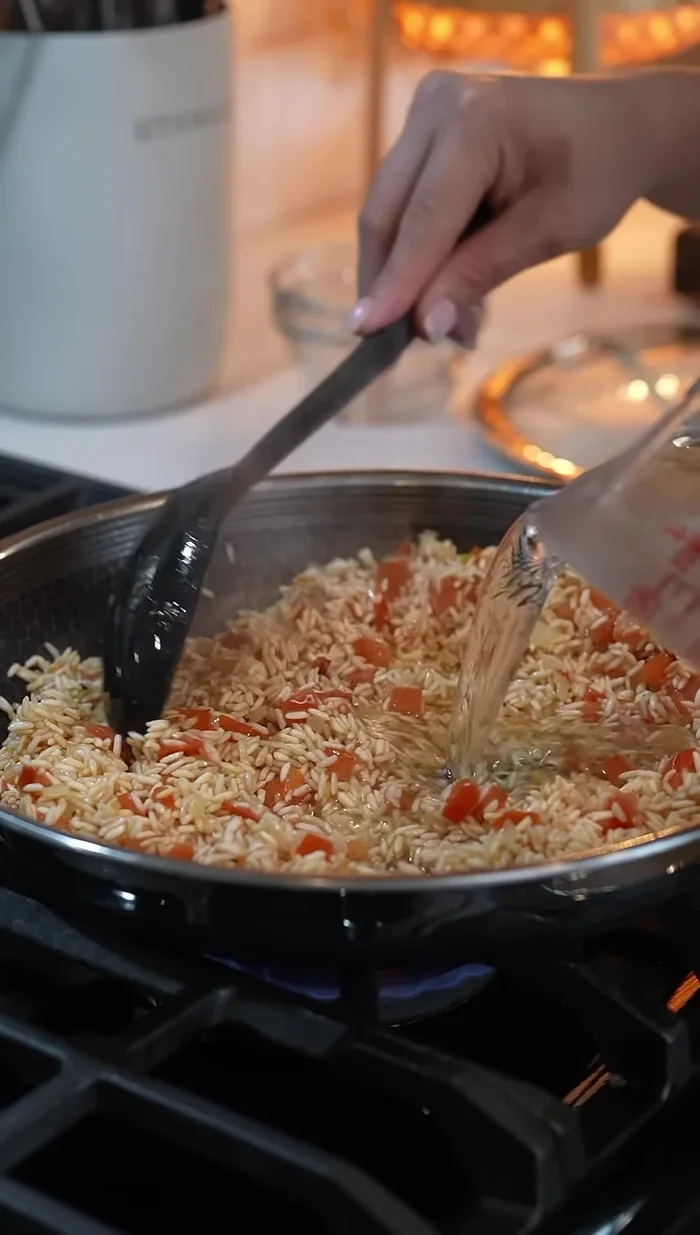 Add 3 cups of water, 1 tbsp tomato paste, 1 tbsp tomato bouan, 1 tbsp chicken bouan, 1 tsp onion powder, 1 tsp garlic powder, and 1/2 tsp ground cumin.