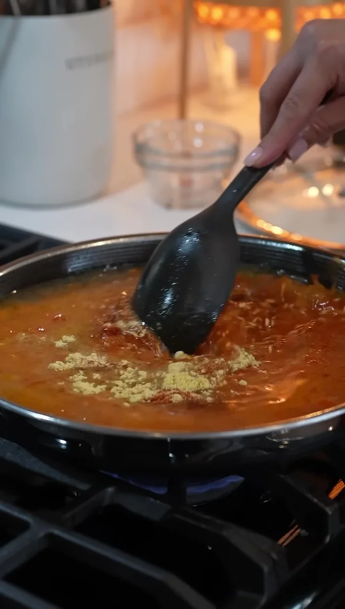 Mix well to dissolve the tomato paste and bring to a simmer.