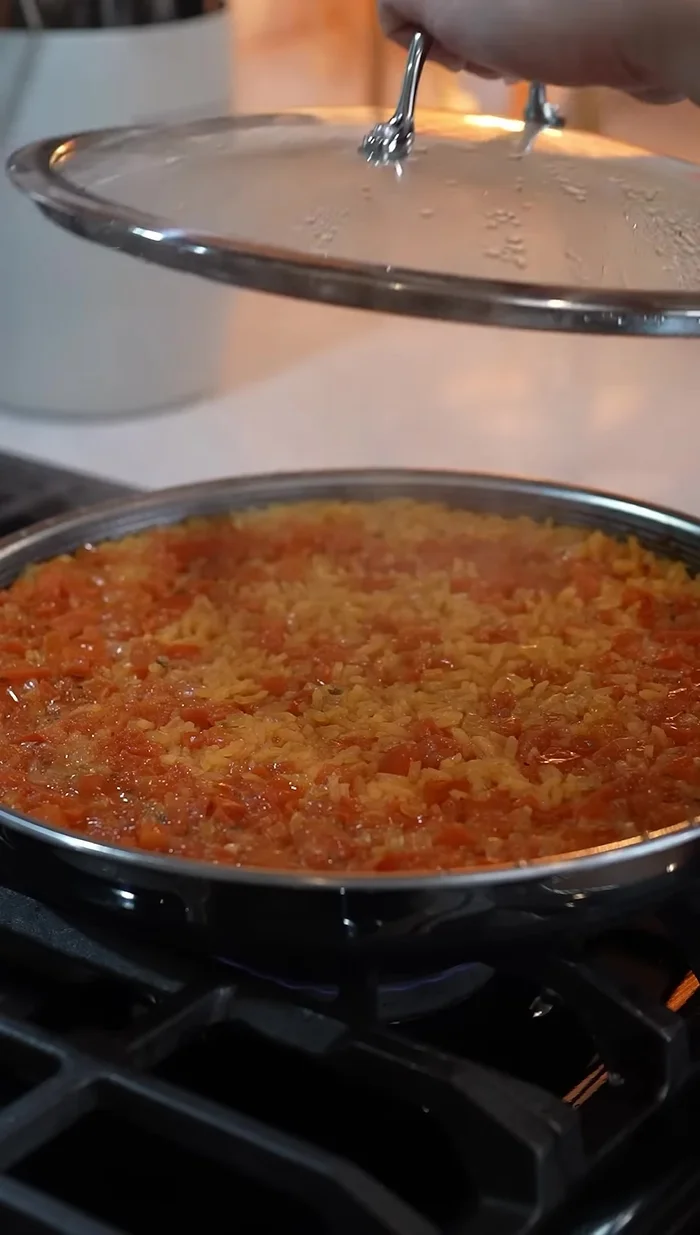 Fluff the cooked rice and cover for 5 minutes.