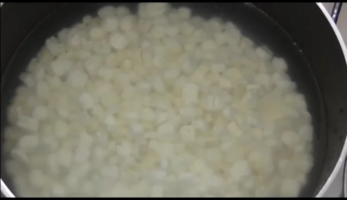 Rinse precooked corn 2-3 times to remove preservatives. Boil twice, discarding the water each time, to ensure preservatives are completely removed. This prevents a milky consistency in the final dish.