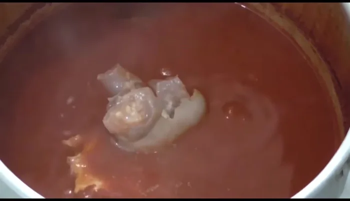 Add the cooked beef belly, epazote, and simmer for 10-15 minutes to allow the flavors to meld.