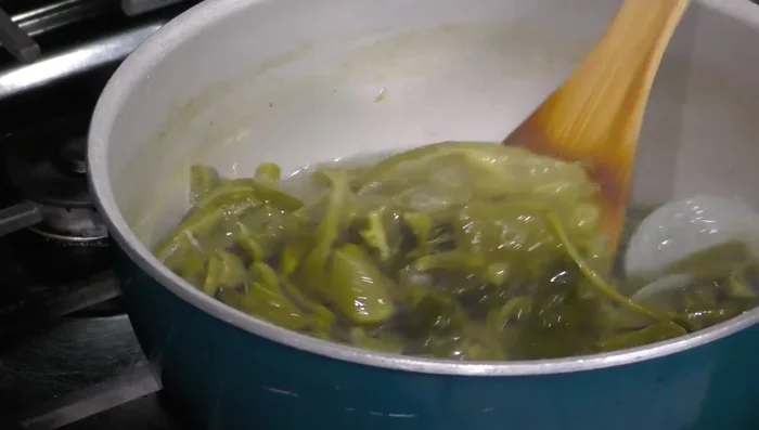 Let nopales cool, then pass through a colander to remove tomato peels, onion, and cilantro. (93.159)
