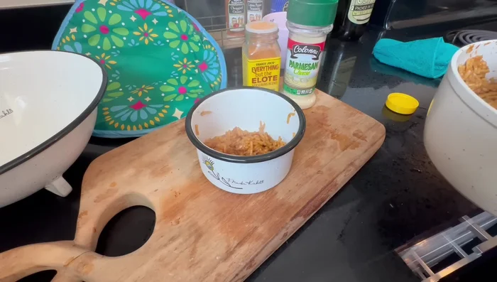 Assemble the bowls. Layer rice, chicken mixture, and sauce in bowls. Top with additional Parmesan cheese and elote seasoning as desired. (Start at 495.52)