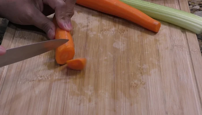 Prepare vegetables: peel and chop carrots, celery, and potato (keep potato in water to prevent browning).