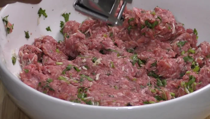 Add a crushed garlic clove to the meat mixture and mix until combined. You can use mint instead of cilantro.