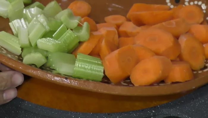 Add carrots and celery to the sauce.
