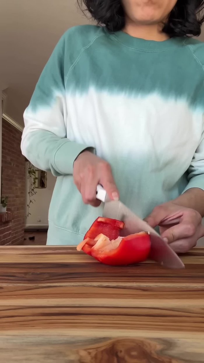 Cut a bell pepper in half, remove the tops and inards, then cut into evenly sized strips.
