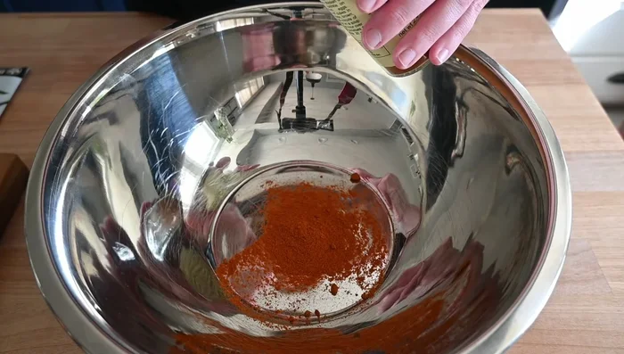 In a bowl, combine paprika, cumin, onion powder, garlic powder, salt, pepper, and parsley.