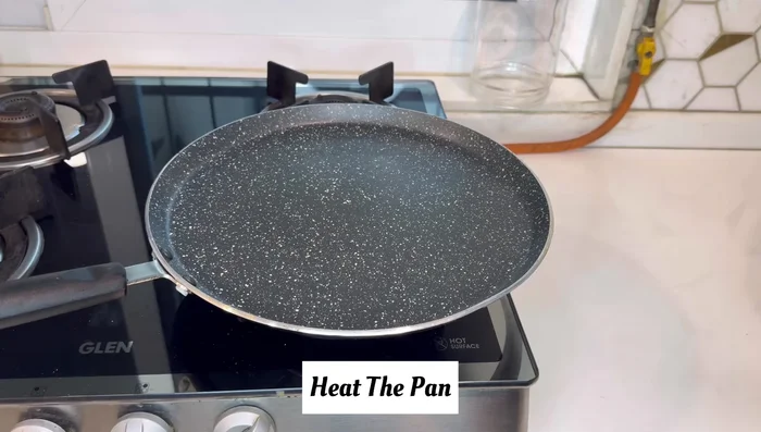 Lightly roast the rotis on a hot non-stick pan until lightly browned on both sides.