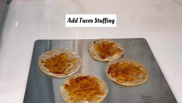 Add the prepared stuffing to the center of each roti. You can add boiled kidney beans to the stuffing if desired.