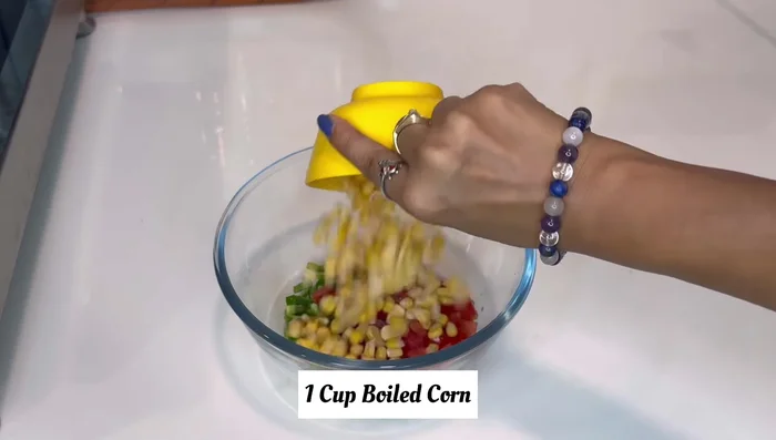 In a bowl, combine the chopped vegetables, black pepper powder, Italian seasoning (or mixed herbs), chili flakes, salt, Schezwan sauce, and tomato ketchup.