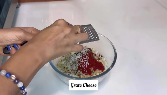 Grate cheese and add it to the vegetable mixture. Mix well. This is your taco stuffing.