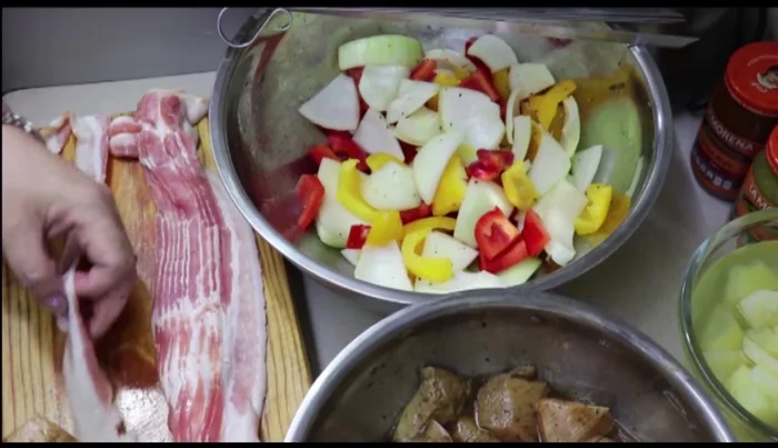 After marinating, remove chicken pieces and wrap each piece with bacon.