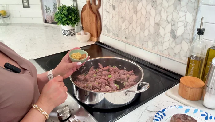 Add 1 tbsp cumin, 1/2 tbsp oregano, 1 tbsp chicken bouillon, salt, pepper, and 3 slices of jalapeno. Mix well.
