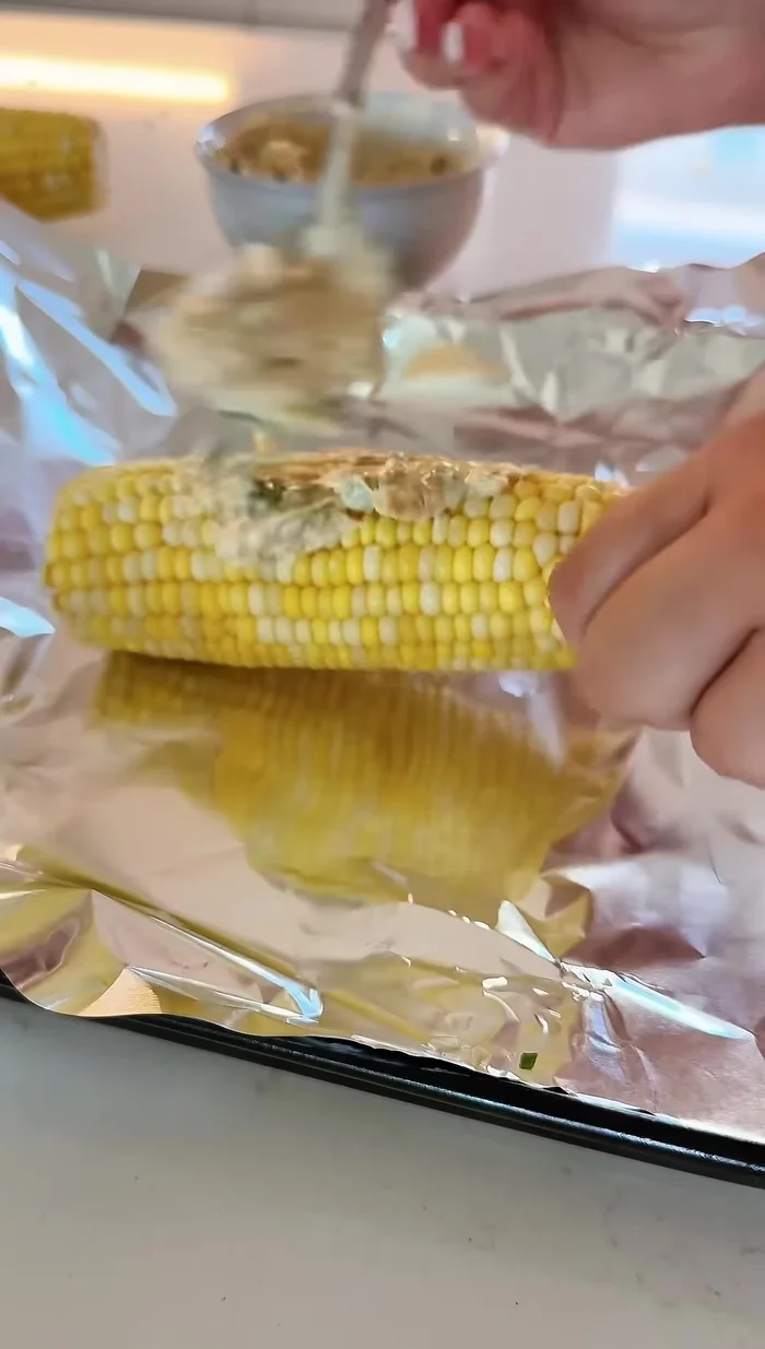Rub the paste generously onto each corn cob.