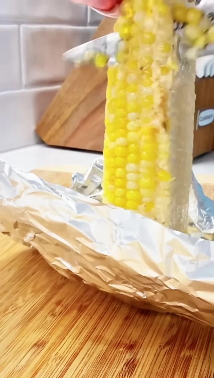 Cut the corn cobs to make them easier to eat (optional).