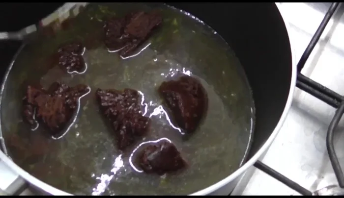 Gradually add the chicken broth, stirring until the mole paste is dissolved. Ensure it doesn't become too watery.