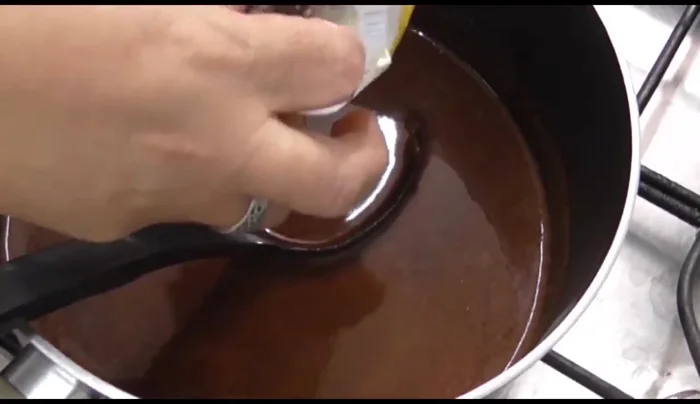 Add the chocolate bar and continue boiling until melted.