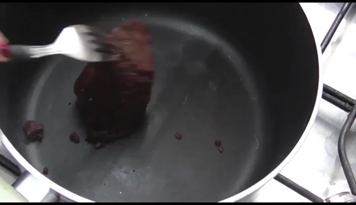 In a saucepan, add the mole paste.